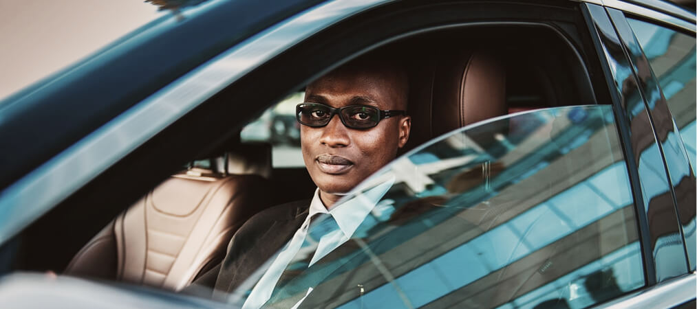 Professional chauffeur driving a luxury car for private transportation service