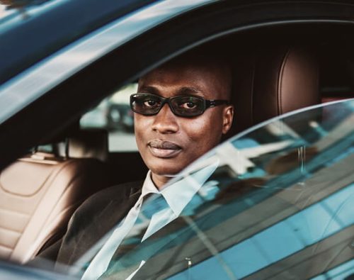 Professional chauffeur driving a luxury car for private transportation service
